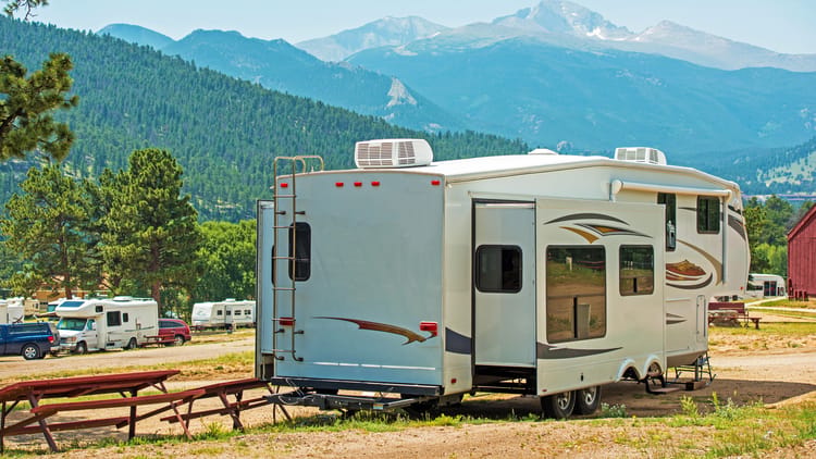 rv-in-picturesque-mountain-campground-under-clear-skies